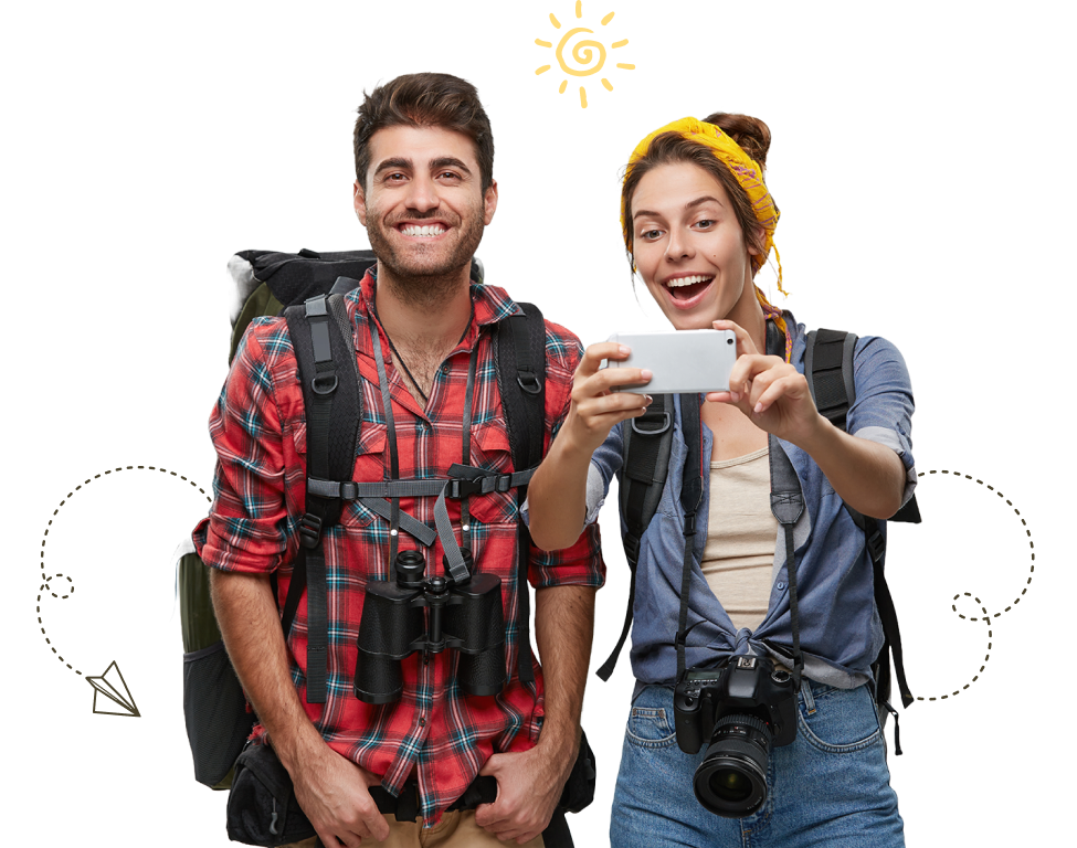 Two happy travelers with backpacks and camera